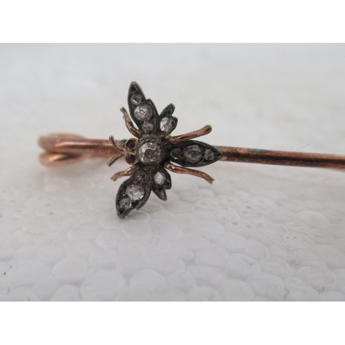 22 - A late Victorian rose gold pin brooch, surmounted by a fly; and a late Victorian decoratively cast y... 