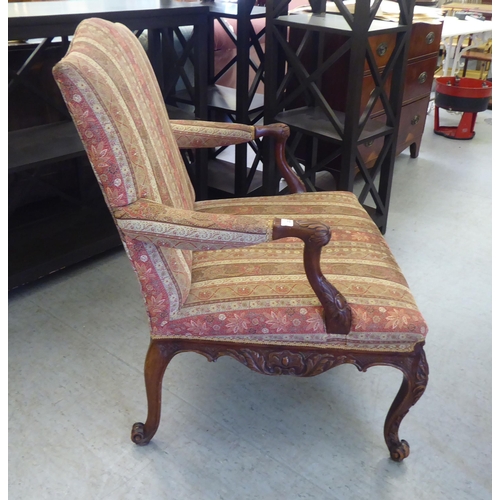 222 - A modern Louis XV design mahogany framed salon chair, upholstered in paisley fabric, raised on cabri... 