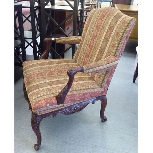 222 - A modern Louis XV design mahogany framed salon chair, upholstered in paisley fabric, raised on cabri... 