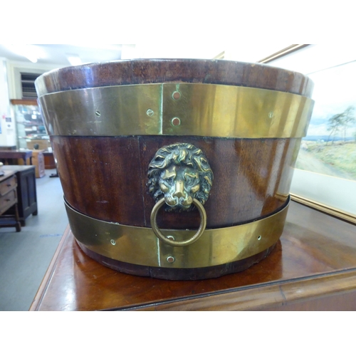 226 - A Regency mahogany brass banded wine cooler with opposing brass lion mask handles  9