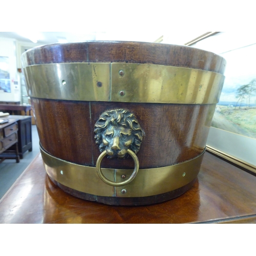 226 - A Regency mahogany brass banded wine cooler with opposing brass lion mask handles  9