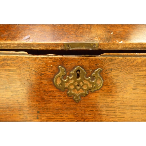 228 - A George III oak bureau with a fall flap, over four graduated drawers, on a plinth and associated st... 