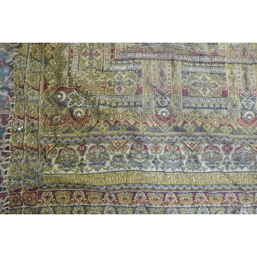 233 - A North African shawl, decorated with stylised designs and tasselled ends