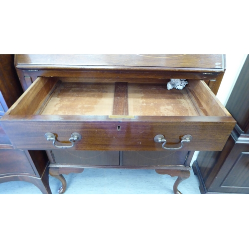 239 - An Arts & Crafts string inlaid mahogany bureau bookcase with a pair of glazed doors, over a fall... 