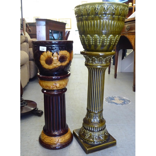 246 - Two West German pottery jardinière pots and stands with floral decoration  25