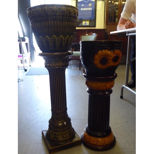 246 - Two West German pottery jardinière pots and stands with floral decoration  25