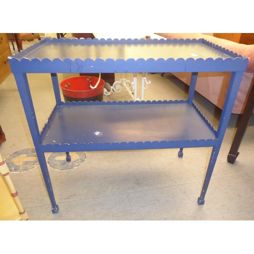 247 - A modern two tier blue painted occasional table, raised on square, tapered legs  32