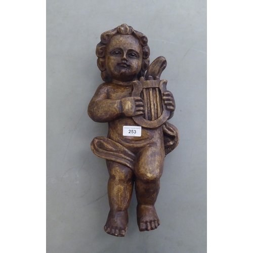 253 - A vintage carved wooden papier mache mould, fashioned as a standing cherub with a lyre  18