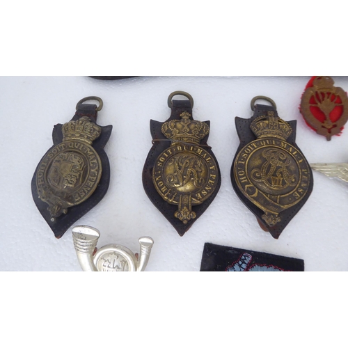 272 - Military and livery horse brasses and cap badges (Please Note: this lot is subject to the state... 