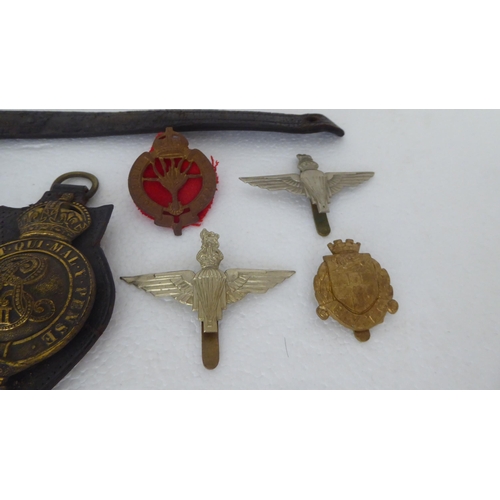 272 - Military and livery horse brasses and cap badges (Please Note: this lot is subject to the state... 