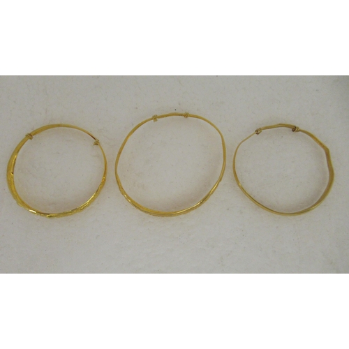 29 - Three Chinese 22ct gold adjustable bangles