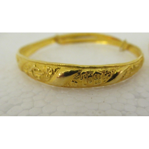 29 - Three Chinese 22ct gold adjustable bangles