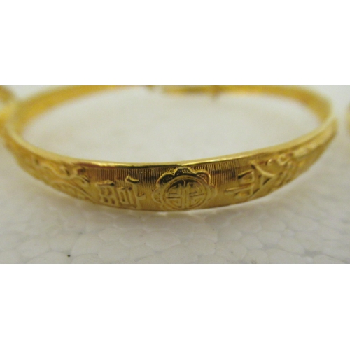 29 - Three Chinese 22ct gold adjustable bangles