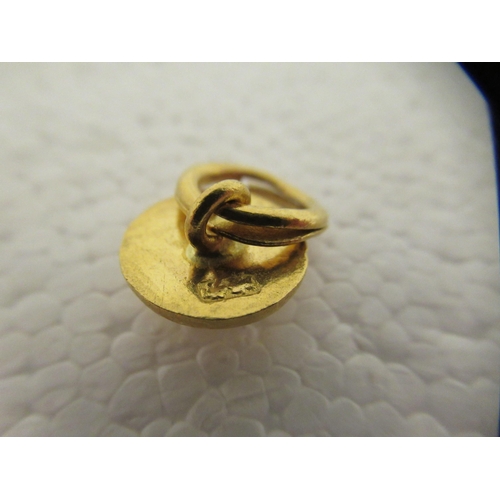 30 - Three Chinese 22ct gold items of personal ornament: to include a heart shaped pendant