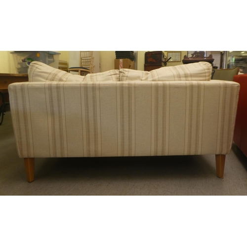 319 - A modern two person settee, upholstered in stripe patterned fabric with cushioned seats, raised on s... 