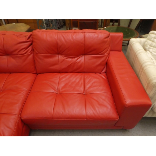 320 - A modern two part corner settee, upholstered in stitched red hide, raised on metal peg feet  65