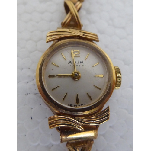 324 - A 9ct gold cased and strapped Avia ladies wristwatch, faced by a baton dial  cased