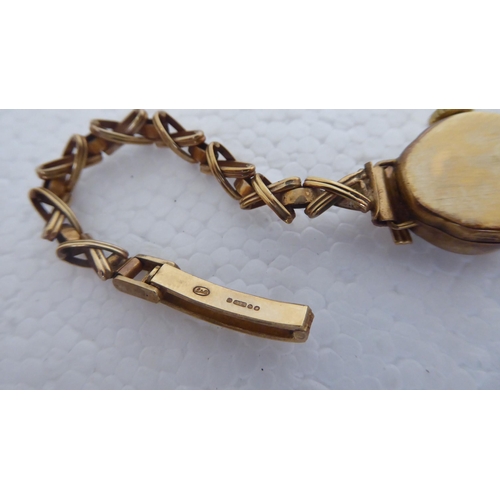 324 - A 9ct gold cased and strapped Avia ladies wristwatch, faced by a baton dial  cased