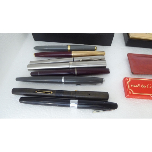 325 - Pens: to include a Must de Cartier rolled gold example  cased 