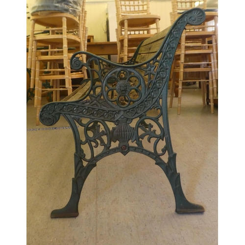 364 - A modern Victorian design garden bench with cast iron ends, a slatted back and seat  50