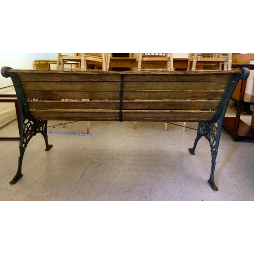 364 - A modern Victorian design garden bench with cast iron ends, a slatted back and seat  50