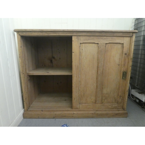 367 - An early 20thC pine cabinet with two sliding doors, on a plinth  38