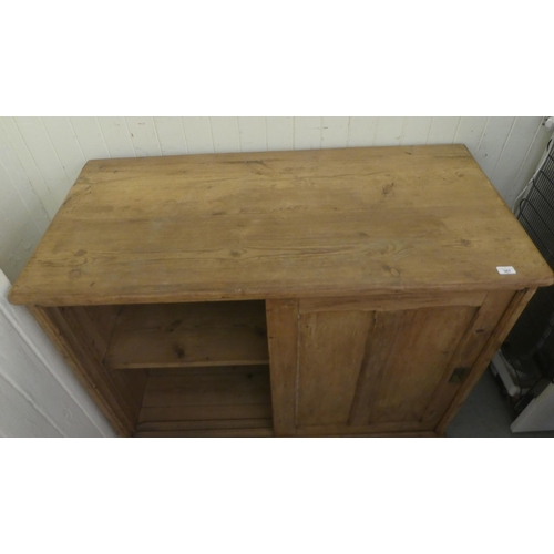 367 - An early 20thC pine cabinet with two sliding doors, on a plinth  38