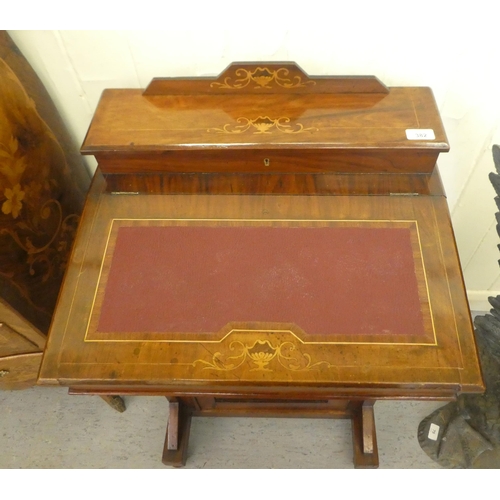 382 - A late Victorian walnut Davenport with a hinged lid, over a panelled front door, raised on turned fe... 