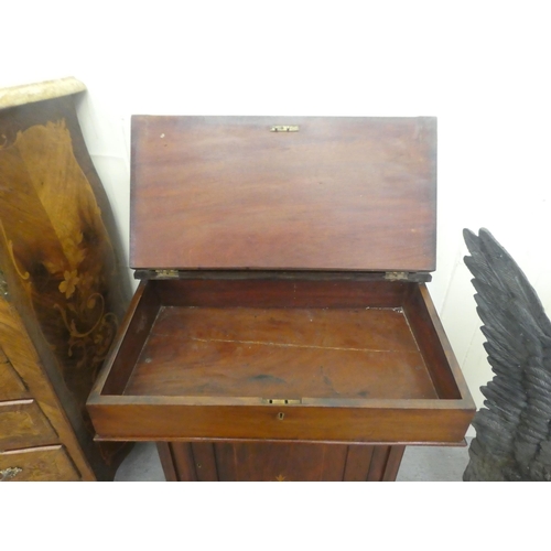 382 - A late Victorian walnut Davenport with a hinged lid, over a panelled front door, raised on turned fe... 