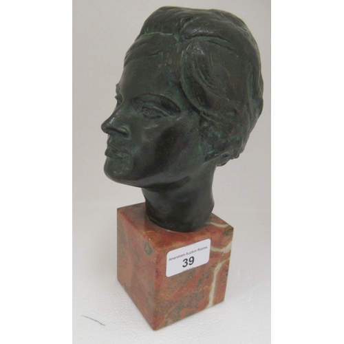 39 - A cast and patinated green bronze bust, a young woman  stamped P Gambino, on a mottled marble p... 