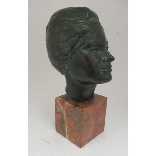 39 - A cast and patinated green bronze bust, a young woman  stamped P Gambino, on a mottled marble p... 