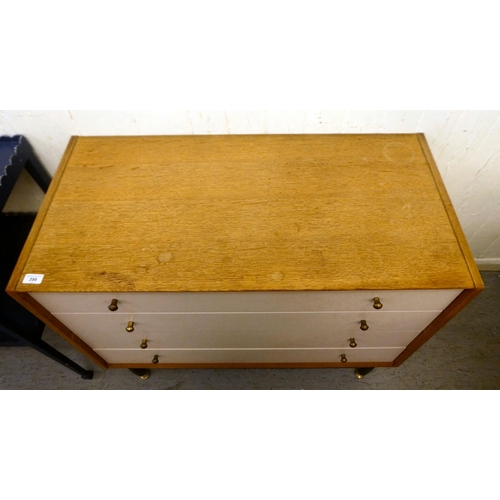 398 - A G-Plan light oak and cream coloured laminate dressing chest of four drawers, raised on turned legs... 