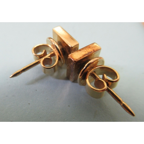 4 - A pair of 14ct gold stud earrings, each set with a diamond 