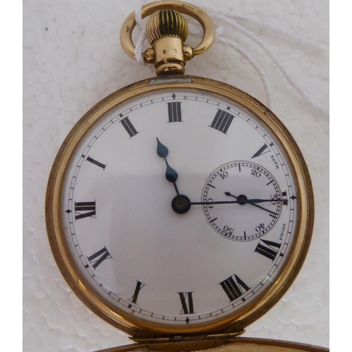 401 - A Dennison 9ct gold cased half-hunter pocket watch, the keyless 15 jewel movement faced by a white e... 