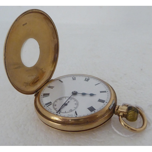 401 - A Dennison 9ct gold cased half-hunter pocket watch, the keyless 15 jewel movement faced by a white e... 