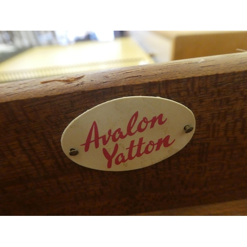 402 - A 1960s oak and cream coloured laminate four drawer dressing chest, raised on turned legs and button... 