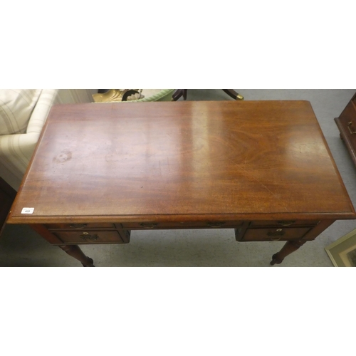 409 - A late Georgian mahogany kneehole desk, comprising five drawers with cockbeading and brass bail hand... 