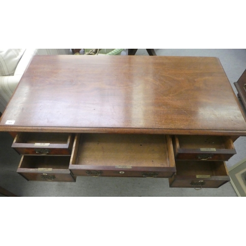 409 - A late Georgian mahogany kneehole desk, comprising five drawers with cockbeading and brass bail hand... 