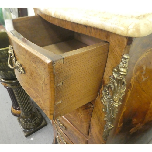 411 - An early 20thC Louis XV inspired satinwood inlaid Kingwood pedestal chest with a serpentine front, m... 