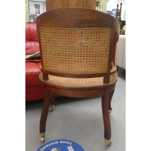 417 - A Colonial style hardwood framed, round back desk chair with scrolled arms, the woven split cane sea... 