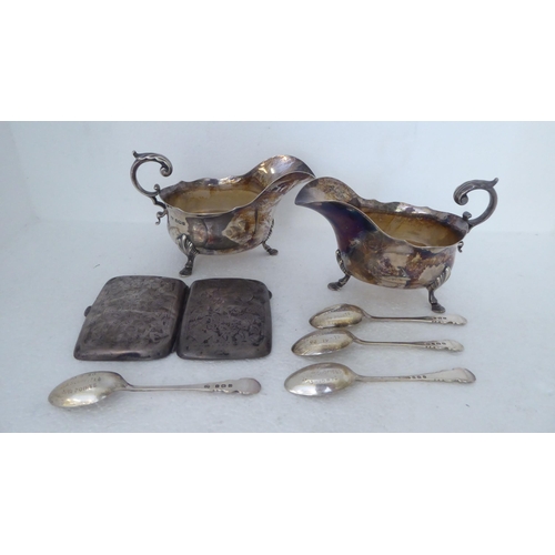 418 - Silver collectables: to include a pair of sauce boats, raised on pad feet  Sheffield 1923 