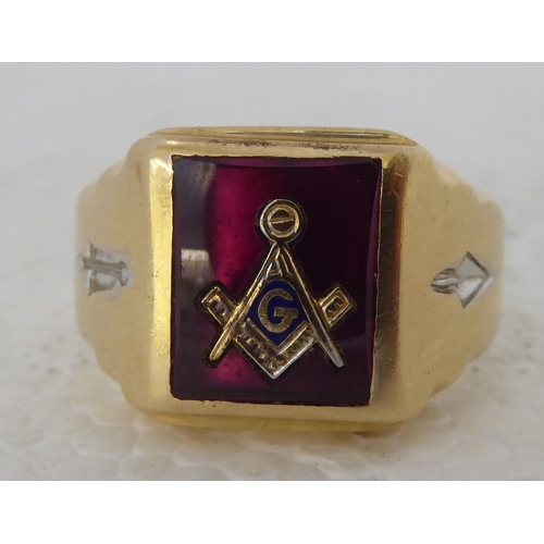 435 - A 14ct gold signet ring with a marquis crest, set in red enamel and decorated with symbols