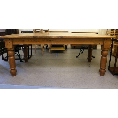 436 - A pine farmhouse table, raised on turned legs  31