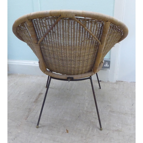 47 - A 1960s woven and split cane Sputnik design chair, raised on a black painted, steel wire underframe