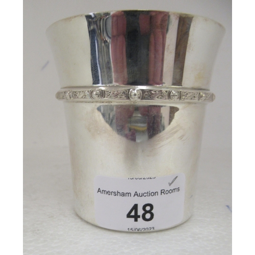 48 - A Scottish silver beaker with a flared rim and cast with Celtic band  Edinburgh 1977