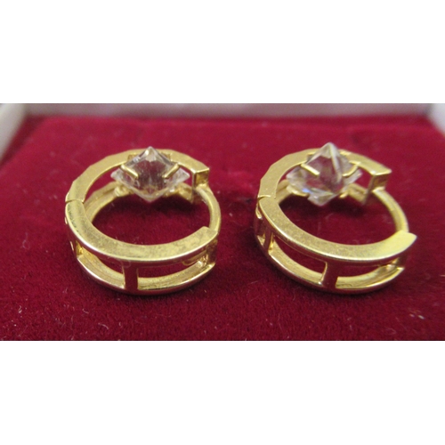 5 - A pair of 18ct gold hoop design earrings, each set with white stones