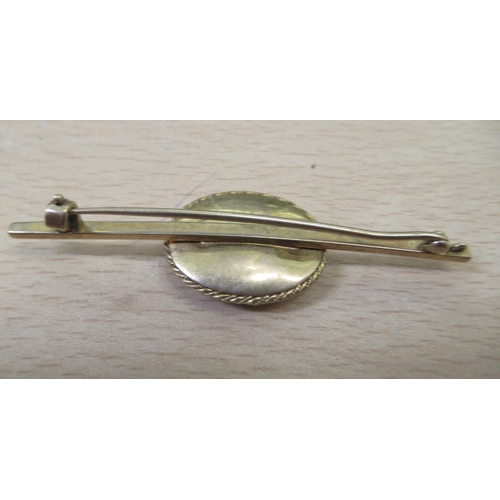 62 - Gold and gold coloured metal items: to include oval pendant medallion and bar brooch 