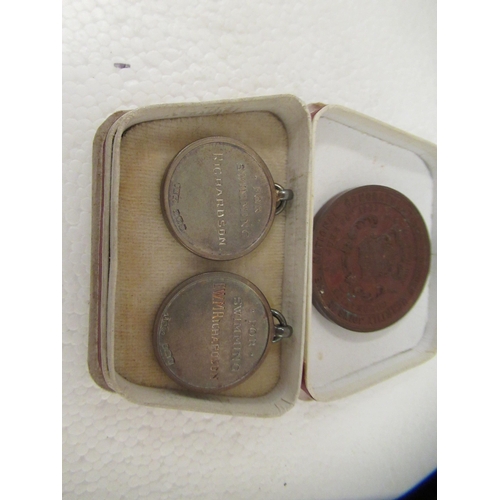 63 - A mixed lot: to include an early 20thC pocket barometer; and two silver swimming medallions 