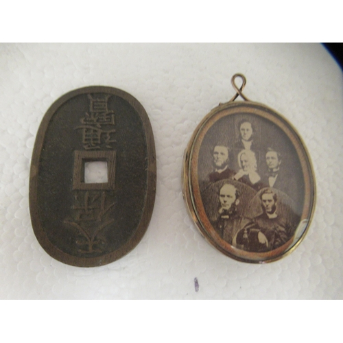 63 - A mixed lot: to include an early 20thC pocket barometer; and two silver swimming medallions 