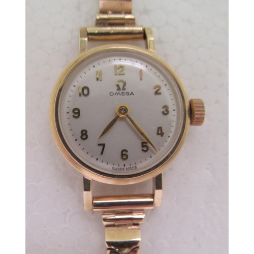 65 - A ladies Omega 9ct gold cased bracelet wristwatch, faced by a gilded Arabic dial, on a flexible stra... 